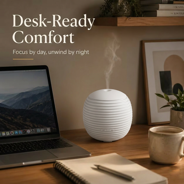 Desk-ready comfort with the mini lantern diffuser on a wooden desk next to a laptop and notebook, providing focus by day and unwinding by night.