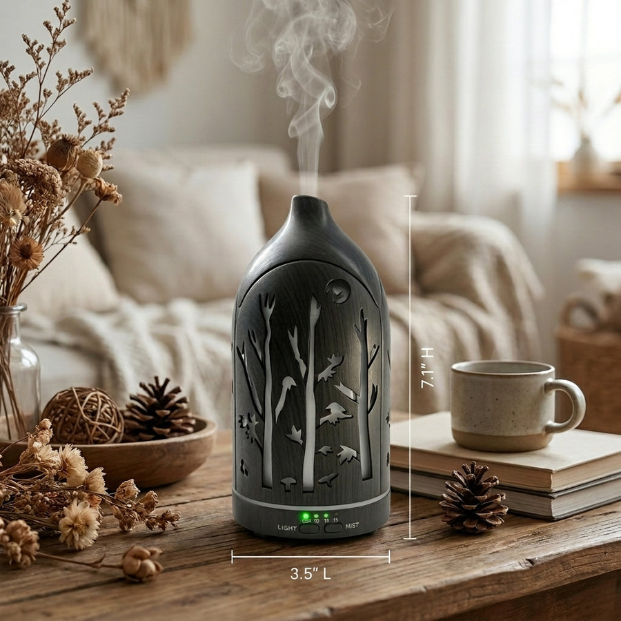 Dark wood forest aromatherapy diffuser with dimensions labeled (7.1 inches height, 3.5 inches length) surrounded by dried flowers and pinecones.