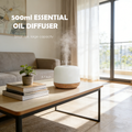 Pniaw 500ml compact essential oil diffuser on a living room coffee table, showing small size dimensions (5.3 inch x 3.7 inch) with large capacity.