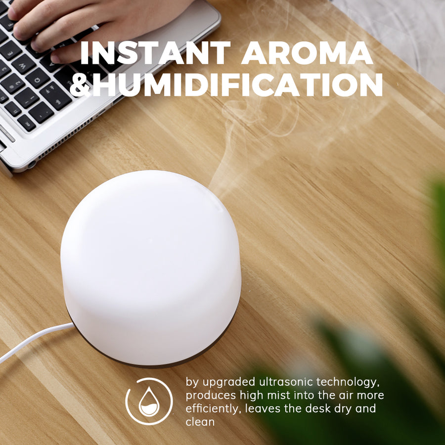 Close-up of Pniaw 500ml diffuser releasing high-volume cool mist via upgraded ultrasonic technology, keeping the desk dry and clean while humidifying.