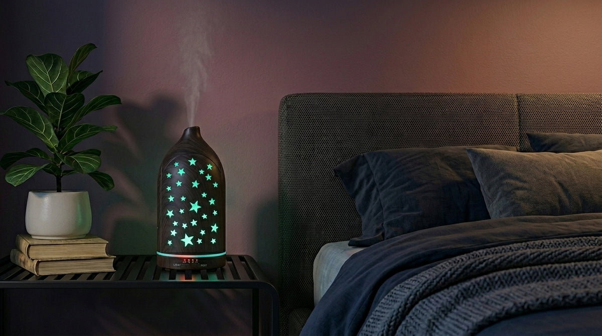 Dark wood grain star cutout diffuser emitting a calming green starlight glow on a modern nightstand in a dimly lit bedroom, next to a fiddle leaf fig plant.