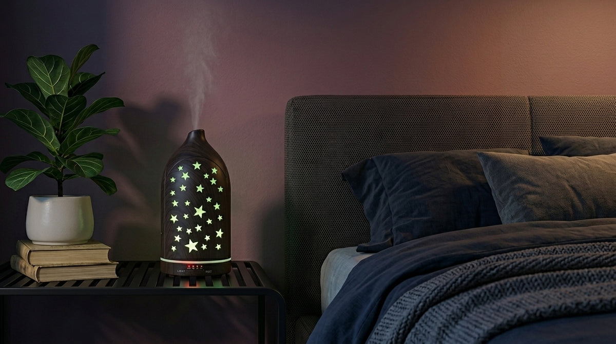 Dark wood grain star cutout diffuser emitting a calming yellow starlight glow on a modern nightstand in a dimly lit bedroom, next to a fiddle leaf fig plant.