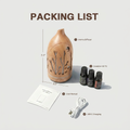 Packing list unboxing of the light wood Forest Aura diffuser set including the device (7.1x3.5 inches), 3 essential oils, user manual, and USB-C charging cable.