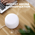 Close-up of Pniaw 500ml diffuser releasing high-volume cool mist via upgraded ultrasonic technology, keeping the desk dry and clean while humidifying.