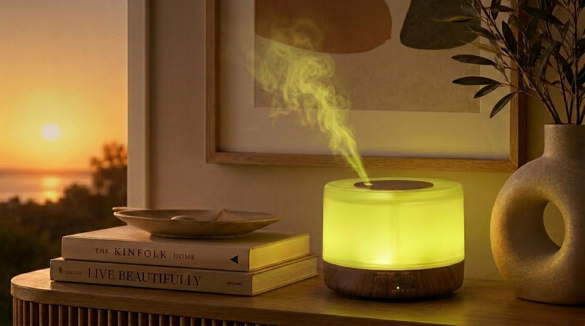 Pniaw round dark wood diffuser glowing with green yellow light on a console table at sunset, styled with books and modern ceramic vase.