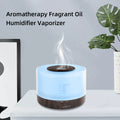 Pniaw dark wood round ultrasonic humidifier vaporizer emitting cool mist with blue LED light, suitable for aromatherapy fragrance oil use.