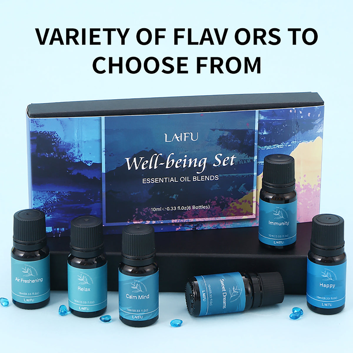 Well-being essential oil gift box with 6 bottles arranged on a black display stand, showcasing the variety of available flavors.